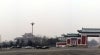 Small parking area, smaller pagoda building, and part of an entryway.