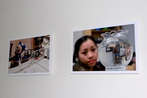 Two photographs displayed on a white wall.