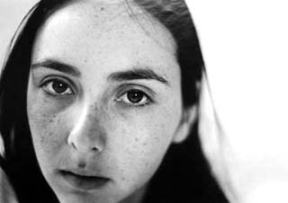 Black and white close-up photo of woman's face.