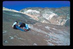 Campers examining a rock face.