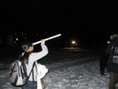 Photo of another student looking through a tube at the night sky.