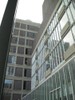 Photo of a building with a grid structure seen through the window.