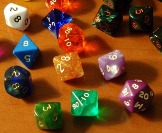 Dice of different shapes and colors.