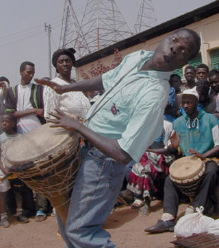 People dancing and playing drums.