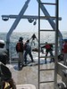 The sensor in tripod frame is winched back onto the ship.