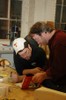 Reuben and a student look at traditional boat designs together.