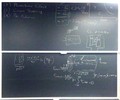 Ion-nuclear interaction related equations on two blackboards.