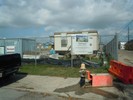 A fenced in construction site where they are rebuilding an elementary school.