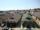 An aerial view of two narrow and long homes.