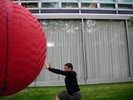 A trick photo makes it appear as if a student will be run over by a giant ball.