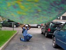 A trick photo makes it appear as if a student is hanging off of a board.