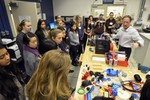 Girls are touring a 3D printing laboratory.